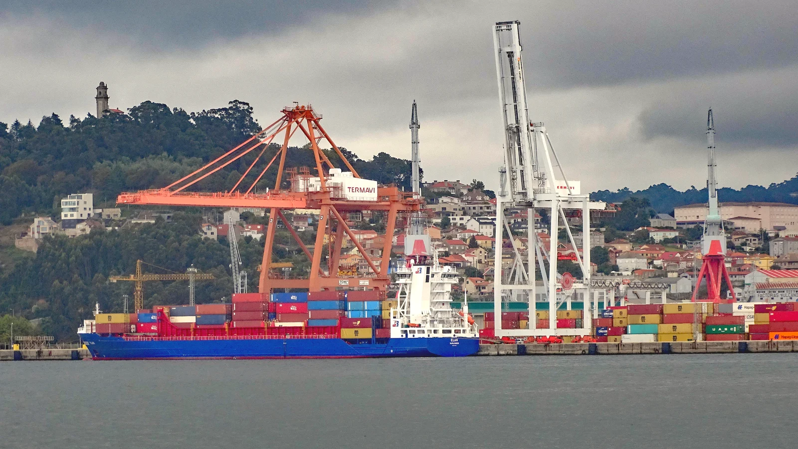 Container ship berthed under gantry cranes in the Port of Vigo on a daytime port call