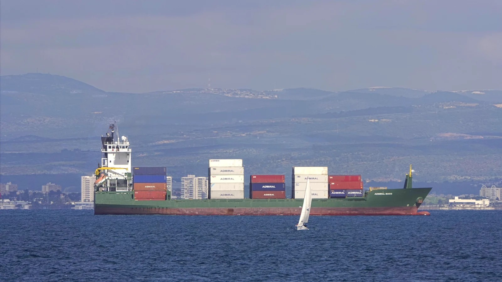 Container ship waiting at anchorage offshore in daylight