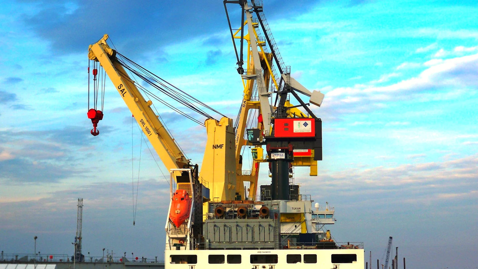 Heavy-lift ship crane hoisting project cargo in port
